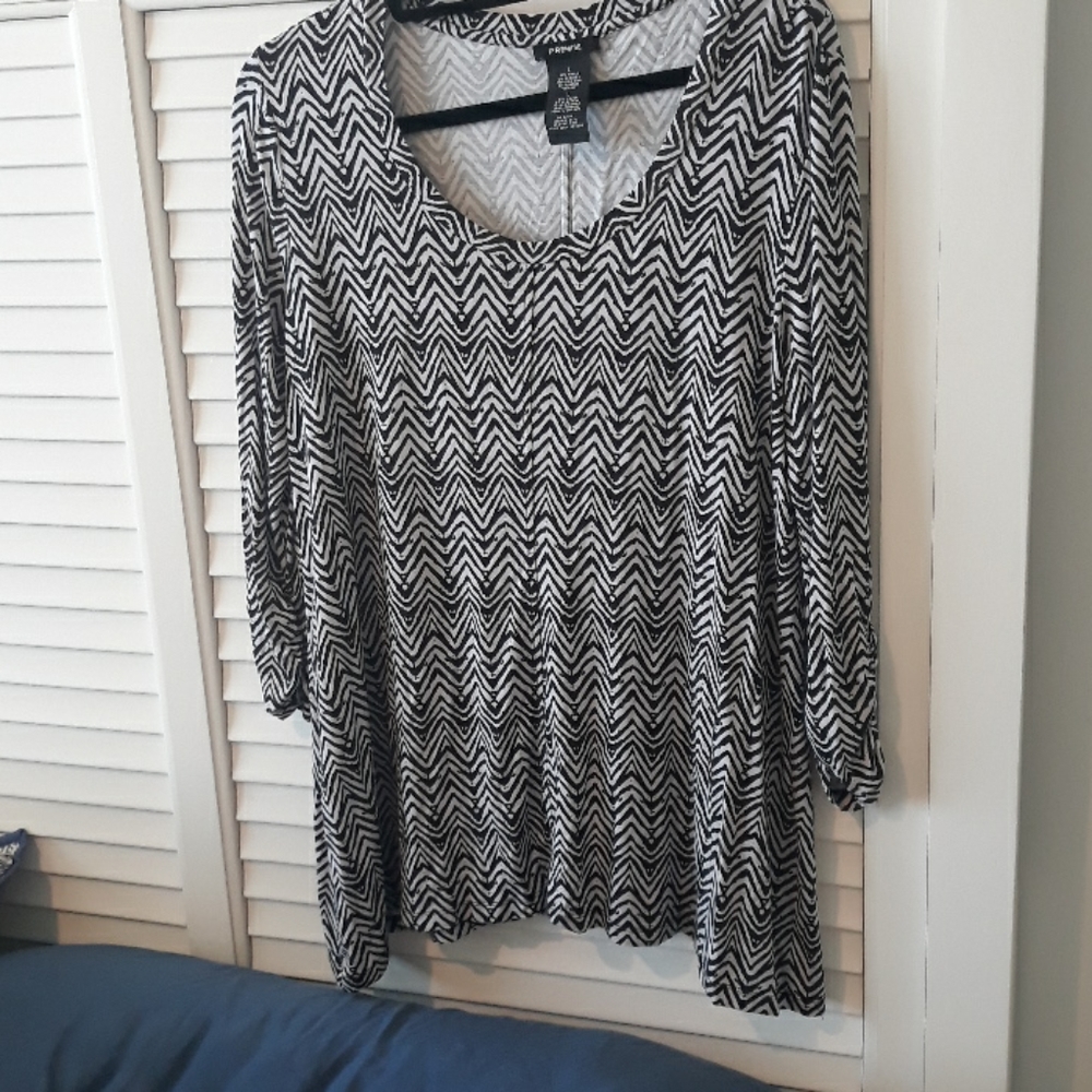 Tunic top with symmetrical modern design. Tunic length, washable knit.